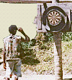 [Man throwing darts at target in the Sepik River jungle village of Tambanum, ESP, PNG: 13k]