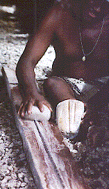 [man polishing a fathom string of shell heishe beads: 21k]