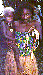 [heishe seller holding her child and shell bead necklaces: 29k]